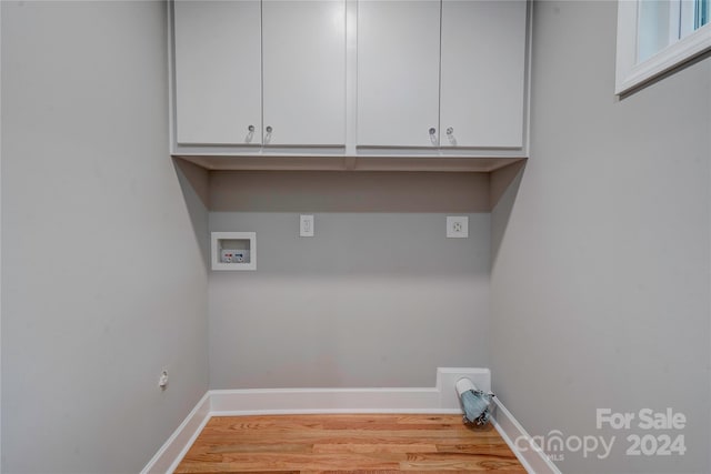 laundry area featuring washer hookup, electric dryer hookup, cabinets, and light hardwood / wood-style floors