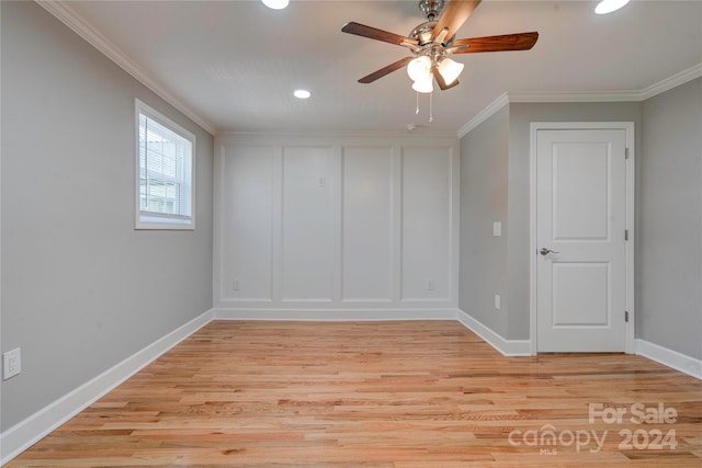 spare room with crown molding, ceiling fan, and light wood-type flooring