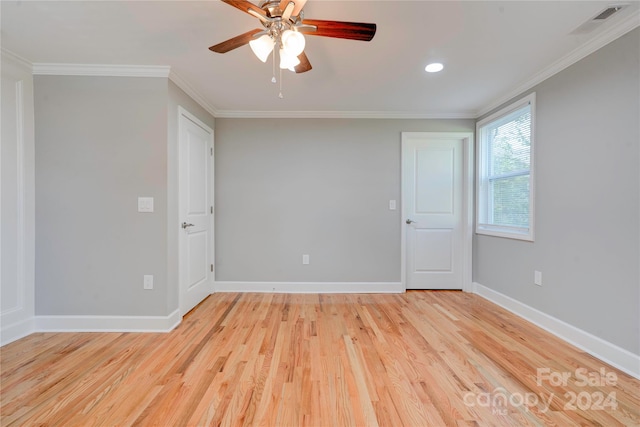 spare room featuring ceiling fan, light hardwood / wood-style floors, and crown molding