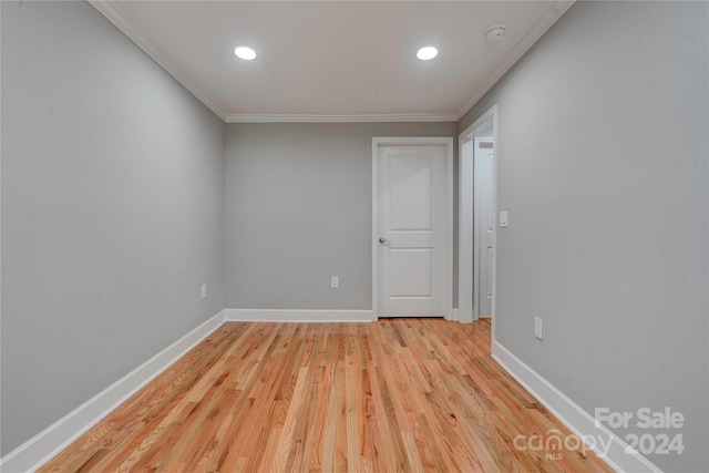unfurnished room with recessed lighting, crown molding, baseboards, and light wood-type flooring