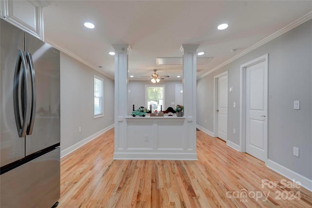 kitchen featuring ornamental molding, stainless steel fridge, ceiling fan, ornate columns, and light hardwood / wood-style floors