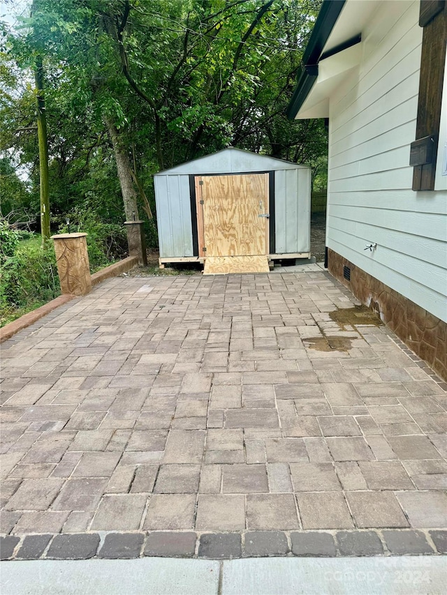 view of patio / terrace with a storage shed