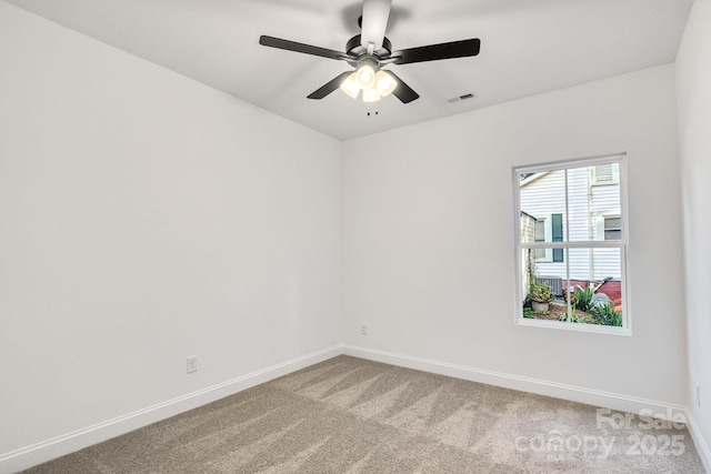 carpeted spare room with ceiling fan