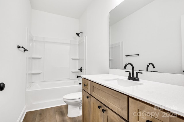 full bathroom featuring hardwood / wood-style flooring, vanity, toilet, and shower / tub combination