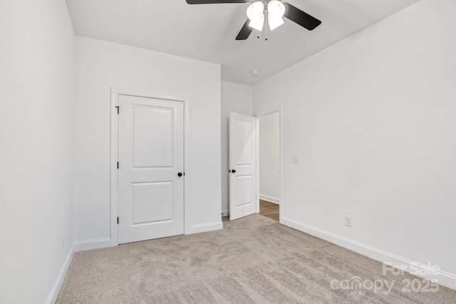 unfurnished bedroom with ceiling fan and light carpet