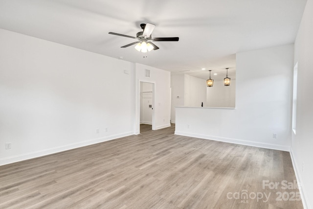 spare room with ceiling fan and light hardwood / wood-style flooring