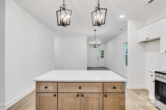 kitchen with electric range, decorative light fixtures, white cabinetry, and light brown cabinetry