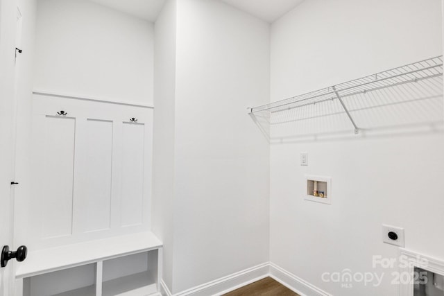 clothes washing area with hookup for an electric dryer, washer hookup, and dark wood-type flooring