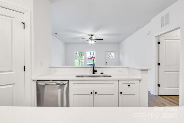 kitchen with dishwasher, light hardwood / wood-style flooring, white cabinetry, and sink