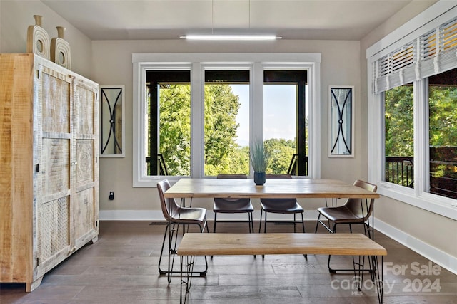 dining space with dark wood-type flooring