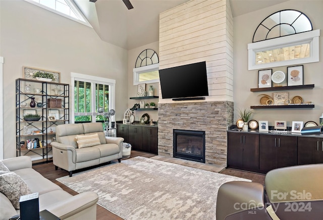 living room with hardwood / wood-style flooring, high vaulted ceiling, and plenty of natural light