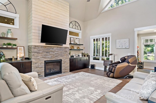 living room featuring light hardwood / wood-style floors, a wealth of natural light, and a high ceiling