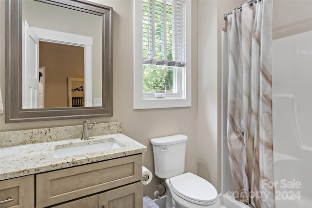 full bathroom with vanity, toilet, and shower / bath combo with shower curtain