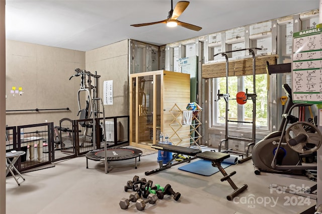 workout area featuring concrete floors and ceiling fan