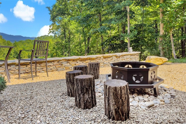 exterior space with a mountain view and a fire pit