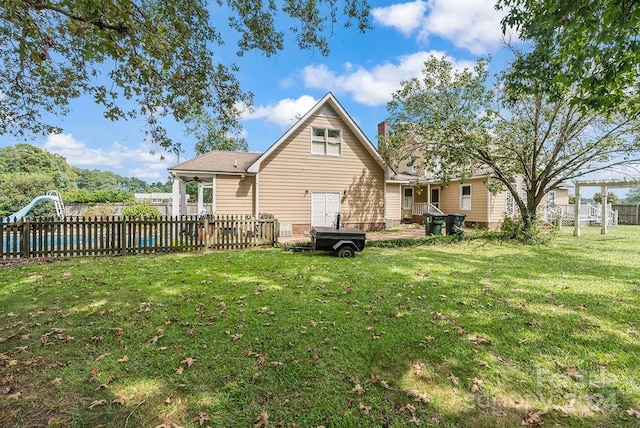 rear view of property with a yard