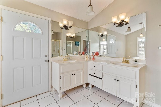 bathroom featuring vanity, vaulted ceiling, tile patterned floors, and walk in shower