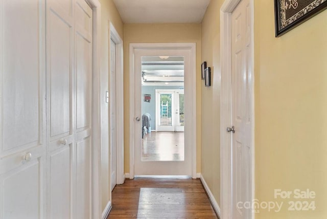 corridor with hardwood / wood-style floors