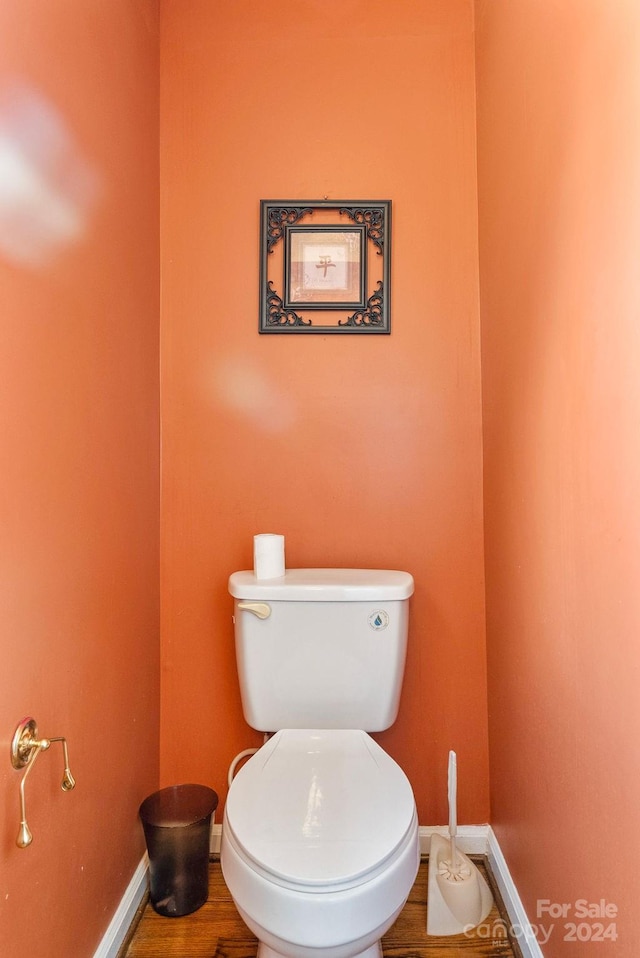 bathroom featuring toilet and wood-type flooring