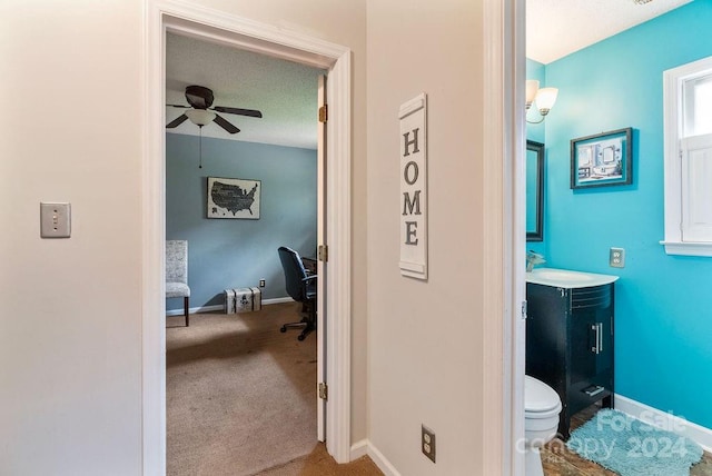 bathroom with ceiling fan, toilet, a textured ceiling, and vanity