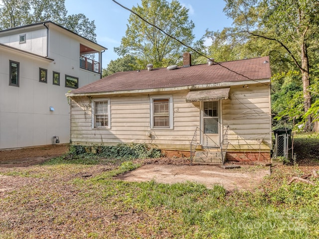 back of property with a balcony