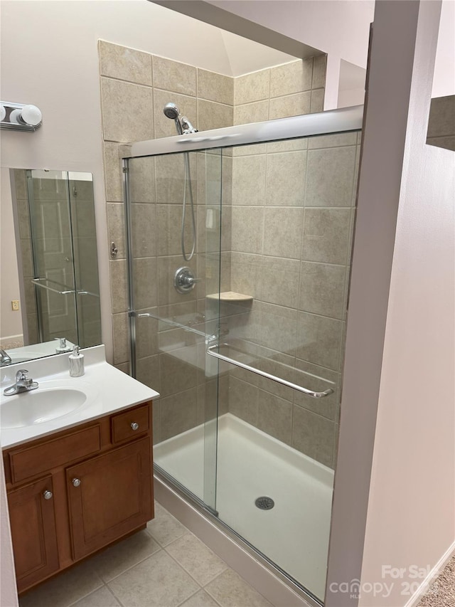 bathroom featuring tile patterned floors, vanity, and walk in shower