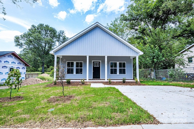 view of front of house with a front yard and a porch