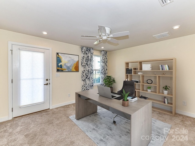 carpeted office with ceiling fan