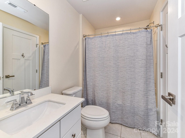 bathroom featuring tile patterned flooring, vanity, and toilet