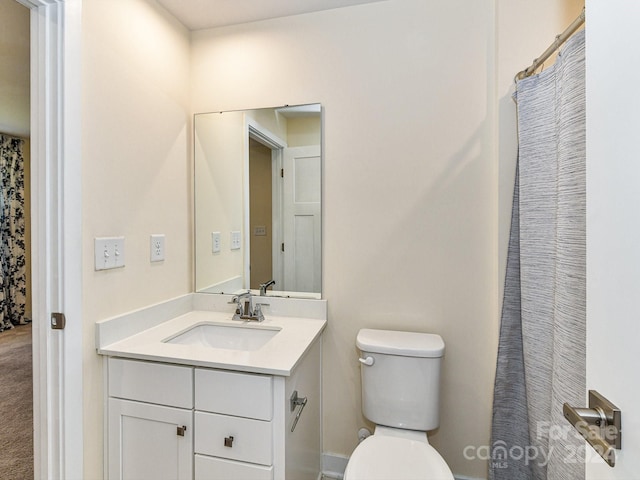 bathroom featuring walk in shower, toilet, and vanity