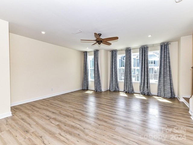 empty room featuring light wood-type flooring and ceiling fan