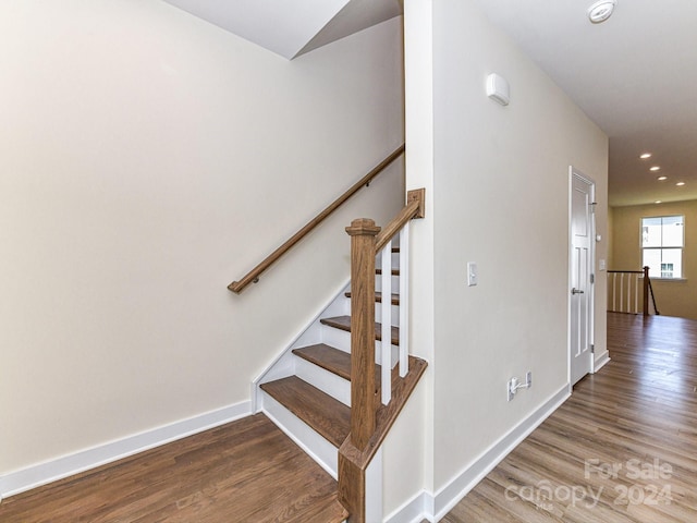 stairs with hardwood / wood-style floors