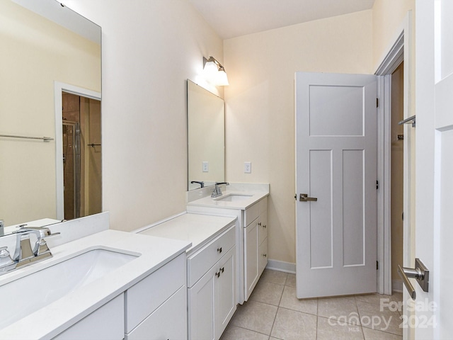 bathroom featuring tile patterned flooring, vanity, and a shower with shower door