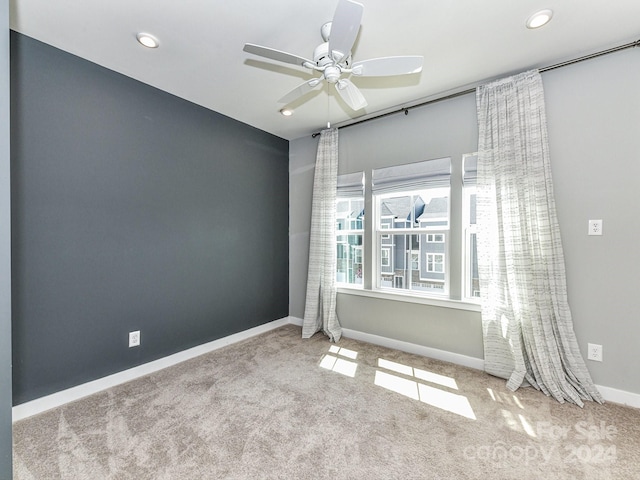 carpeted empty room with ceiling fan