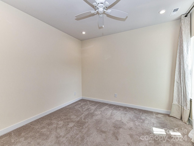 carpeted empty room with ceiling fan