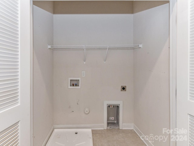 washroom with washer hookup, hookup for a gas dryer, hookup for an electric dryer, and light tile patterned flooring