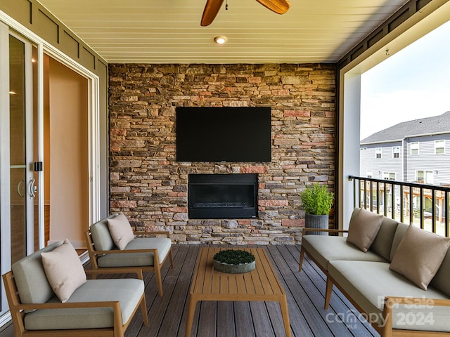 wooden terrace featuring ceiling fan and an outdoor hangout area