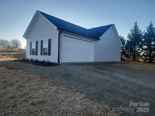 view of side of home with a garage