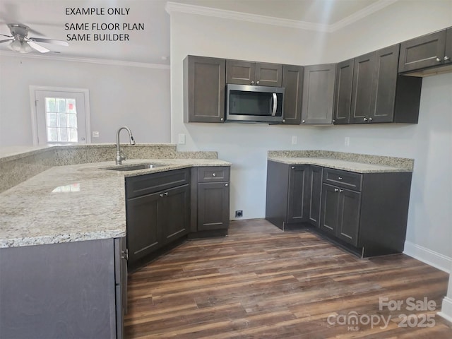 kitchen with ceiling fan, sink, ornamental molding, and kitchen peninsula