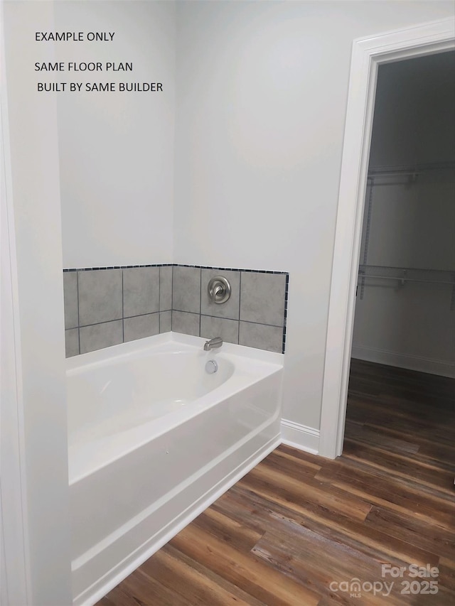 bathroom featuring a bath and hardwood / wood-style floors