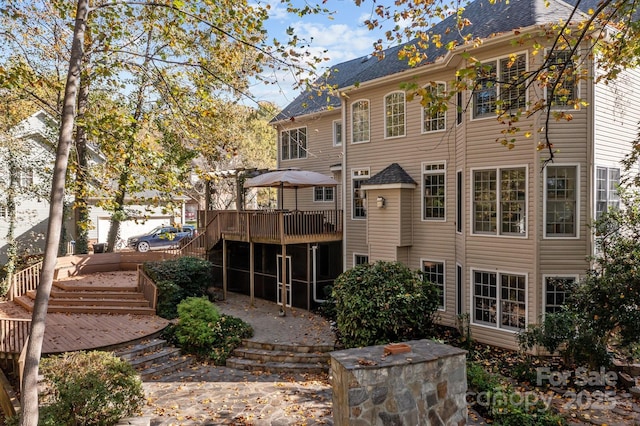 back of house featuring a wooden deck