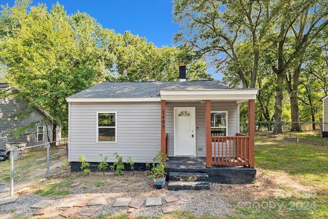 bungalow-style home with a front yard and a porch