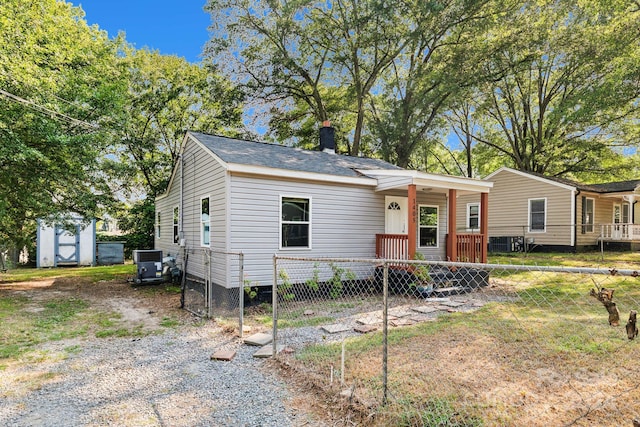 view of front of house featuring a shed and central AC unit