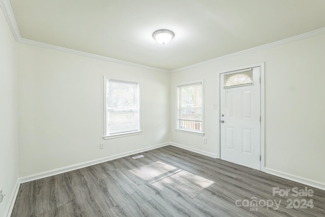 entryway with crown molding and dark hardwood / wood-style floors