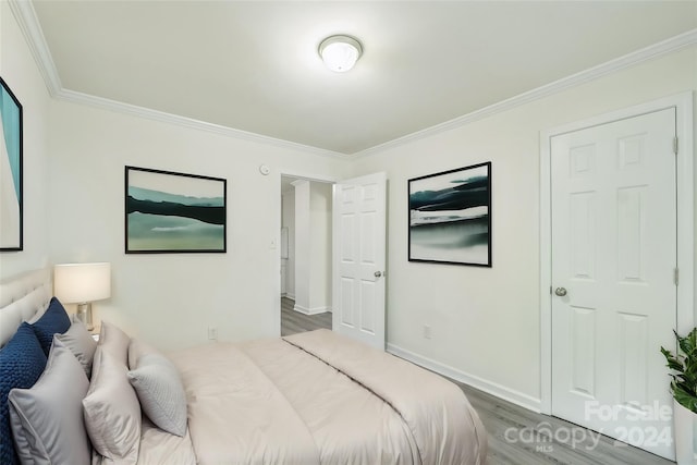 bedroom featuring crown molding and hardwood / wood-style flooring