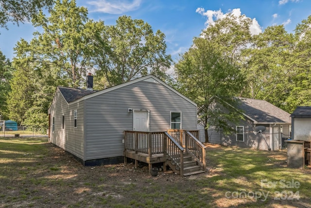 back of house with a yard and a deck