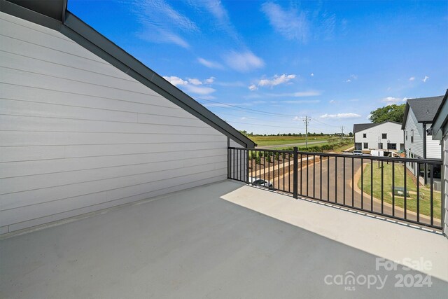 view of patio featuring a balcony