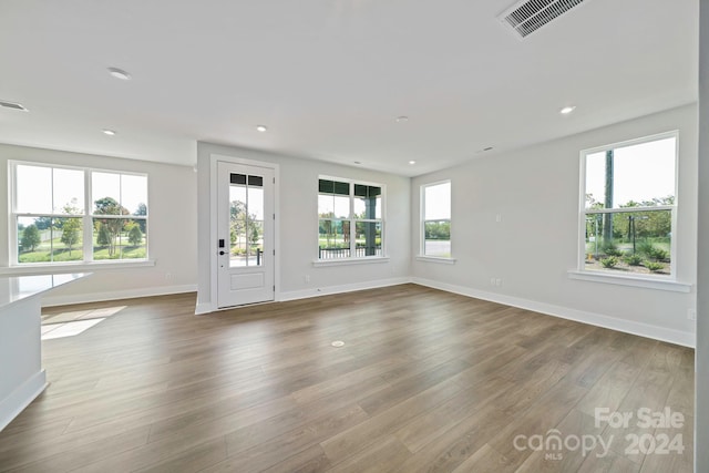 unfurnished living room featuring hardwood / wood-style flooring