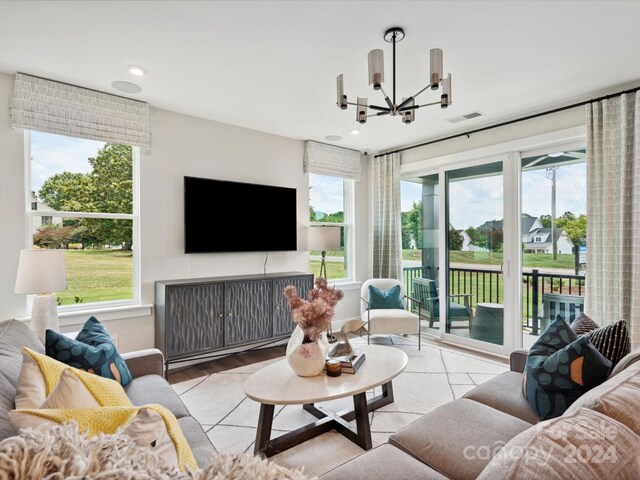 living room featuring a notable chandelier and light hardwood / wood-style floors