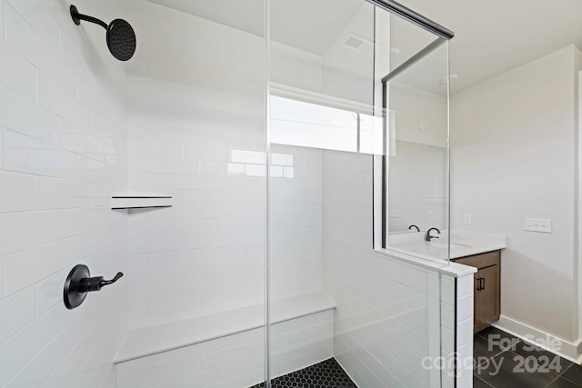 full bathroom with vanity, tile patterned floors, and a tile shower